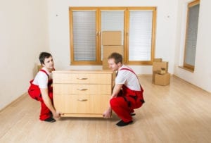 Movers in red moving furniture