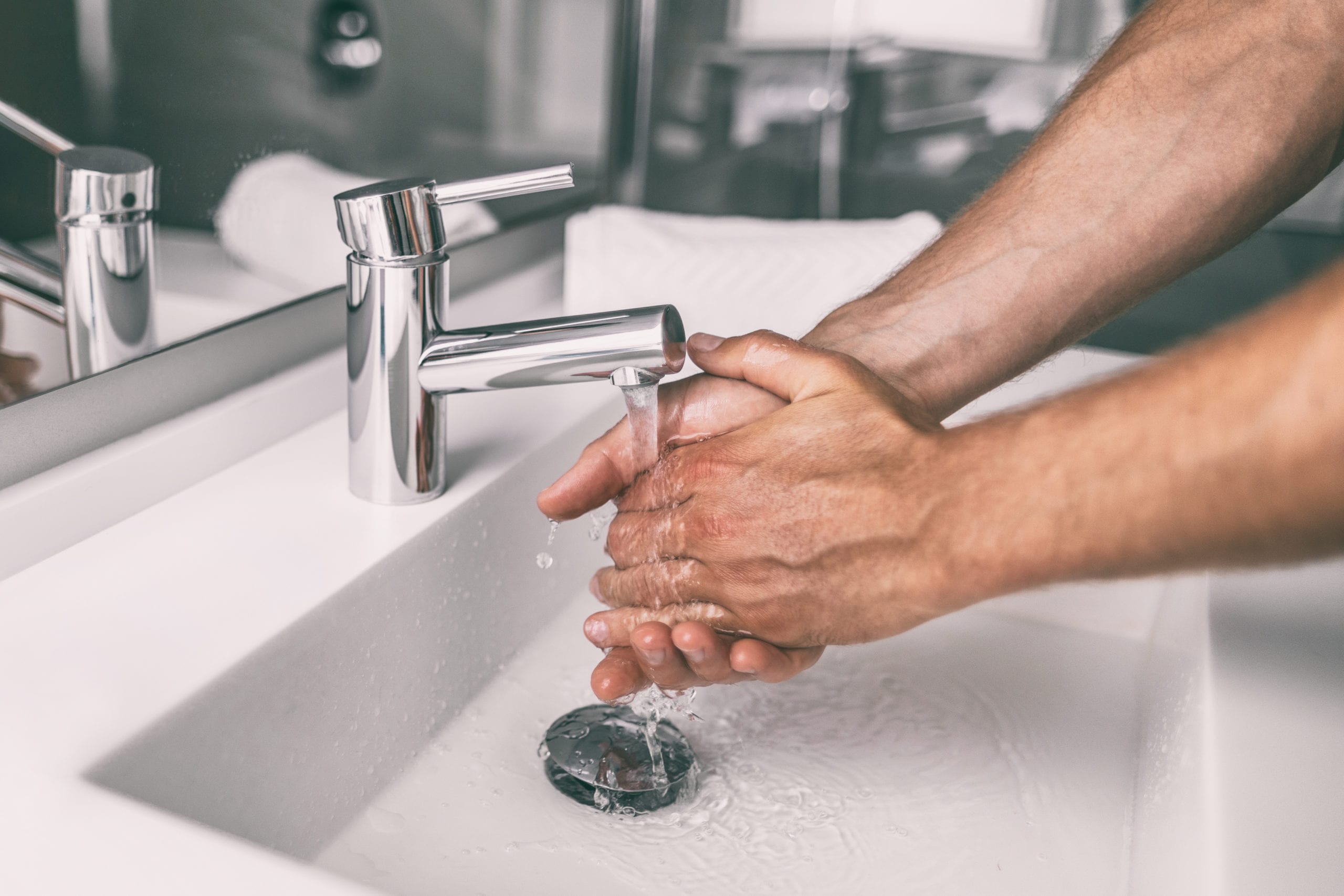 Washing hands rubbing with soap man for winter flu virus prevention, hygiene to stop spreading germs.